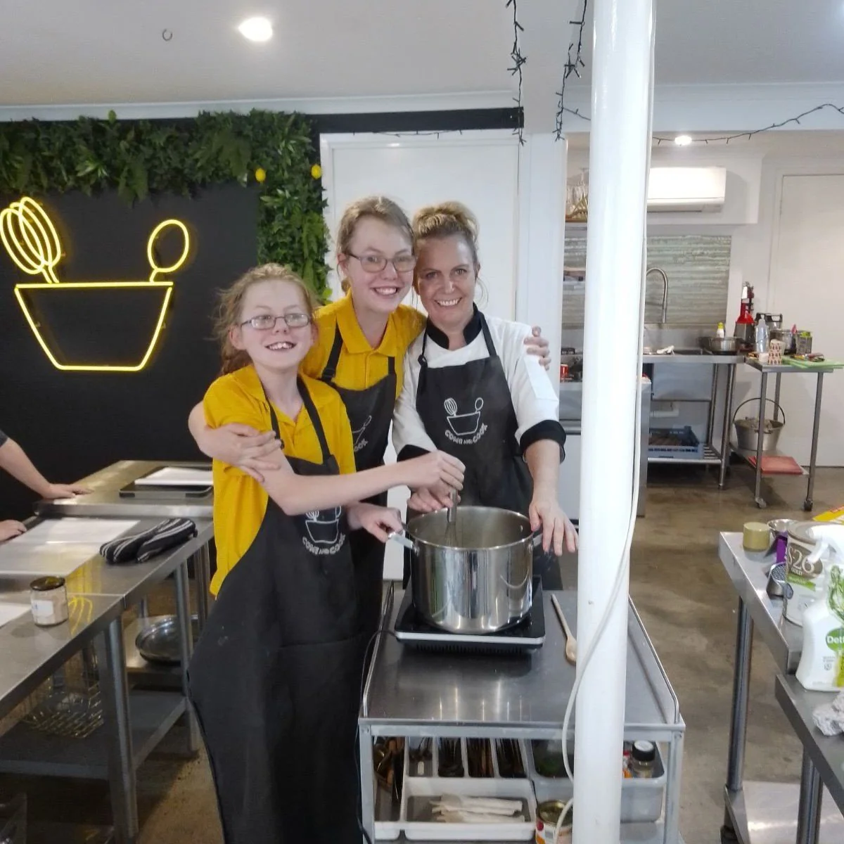 Karen and participants cooking together in the teaching kitchen